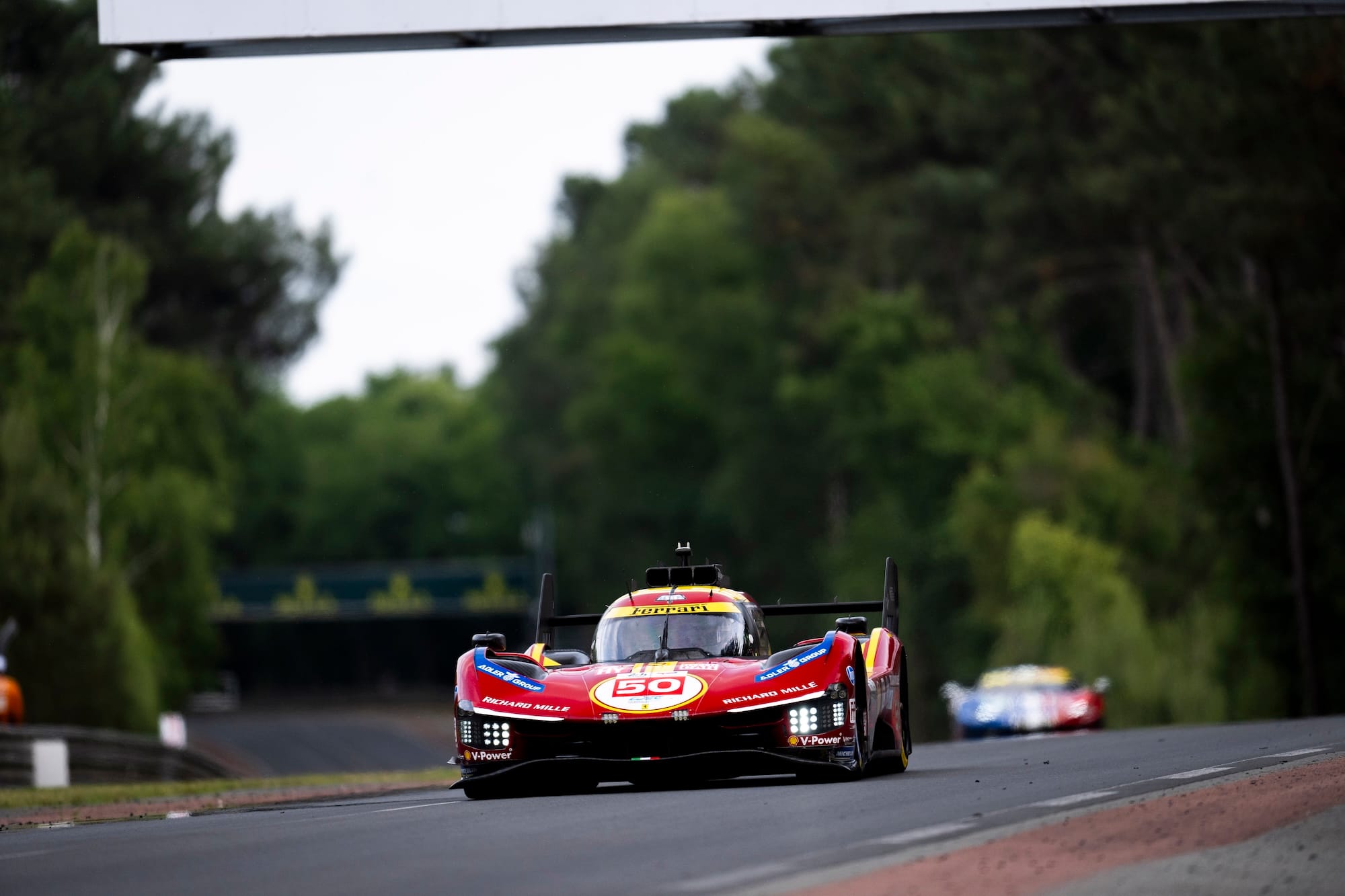 The #50 Ferrari approaching Mulsanne corner at Le Mans 2025, in daylight, head on point of view