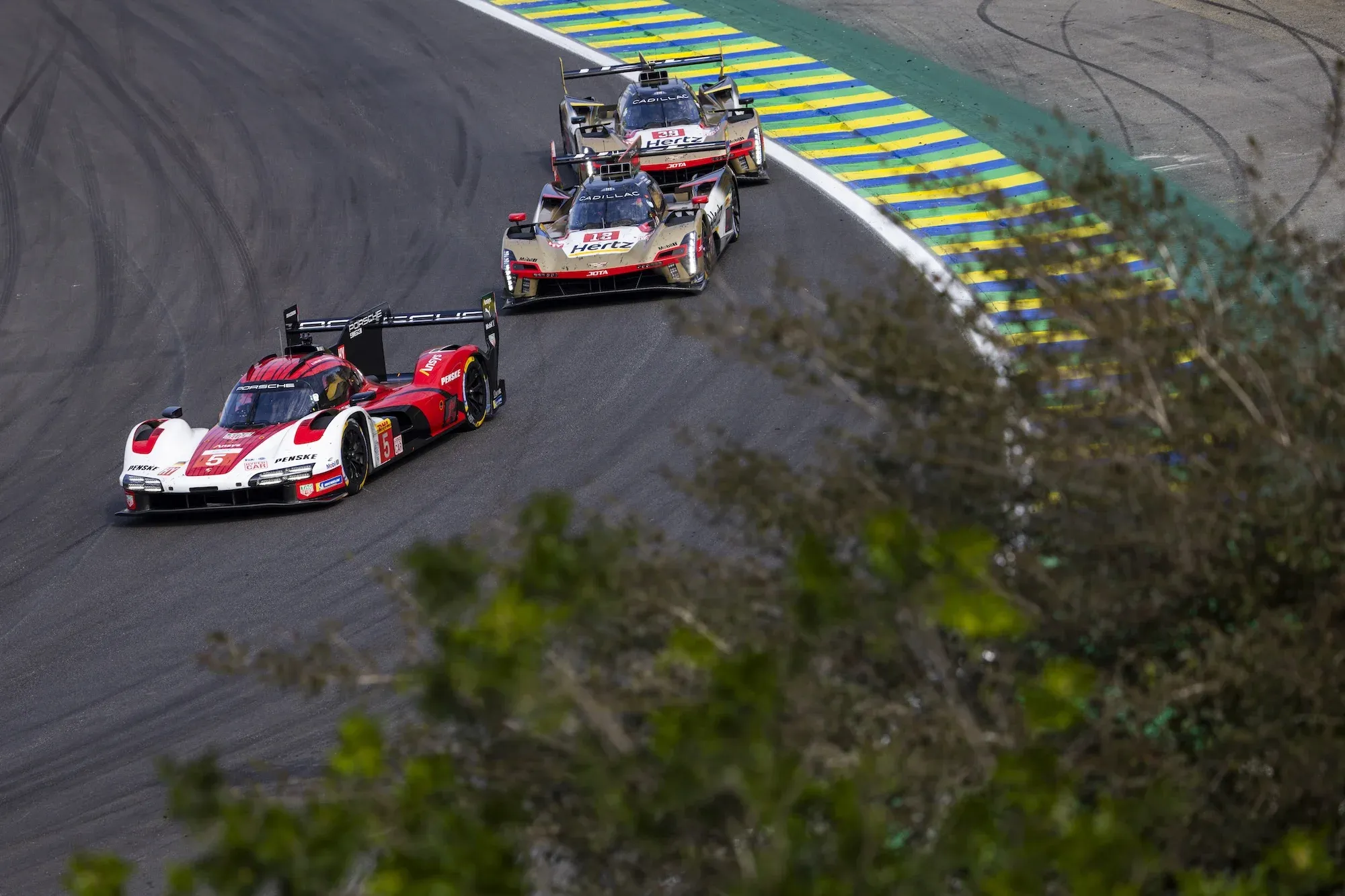 Julien Andlauer in the #5 Porsche leads Will Stevens and Earl Bamber in the two Cadillacs at Interlagos, 2025.