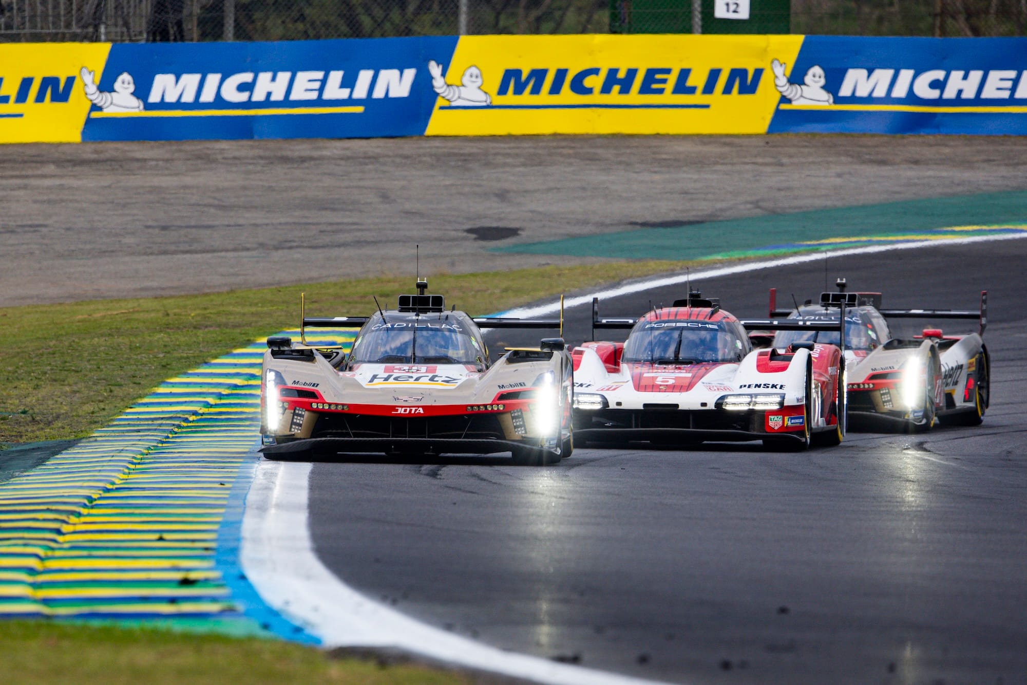 The #38 Cadillac followed by the #5 Porsche and sister #12 Cadillac at Interlagos